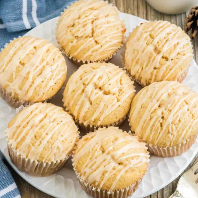 Seven muffins on a white plate.