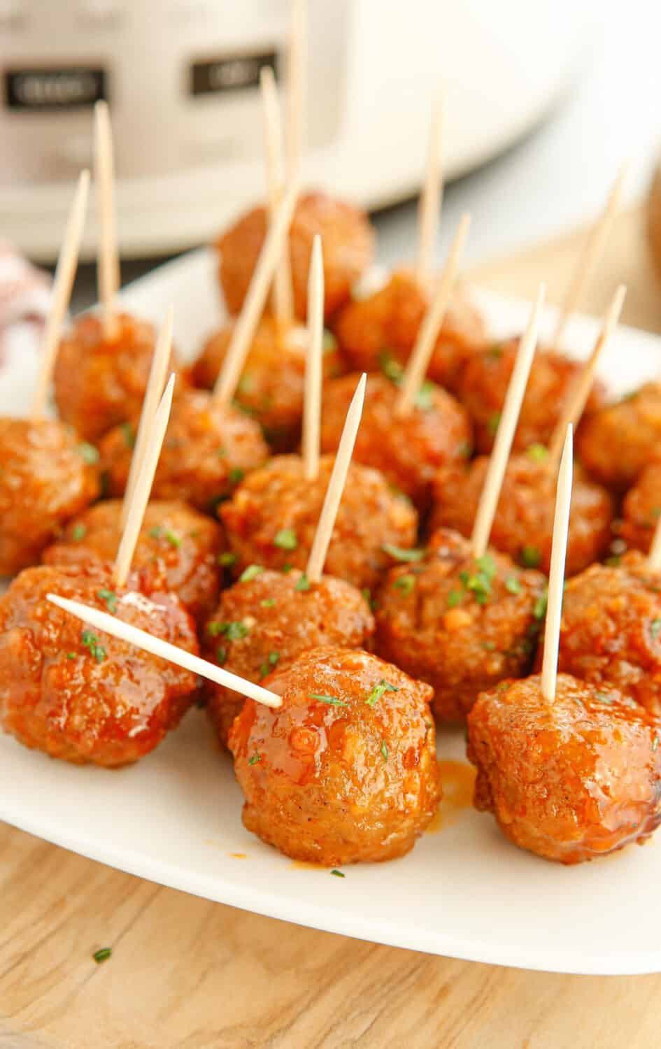 Toothpicks poked into the top of meatballs.