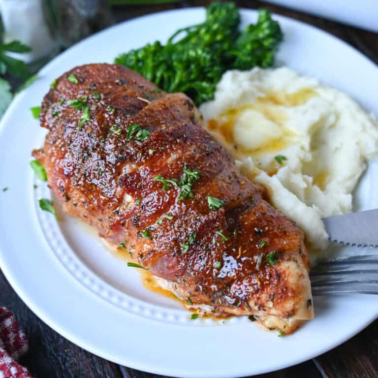 bacon wrapped chicken on a plate.