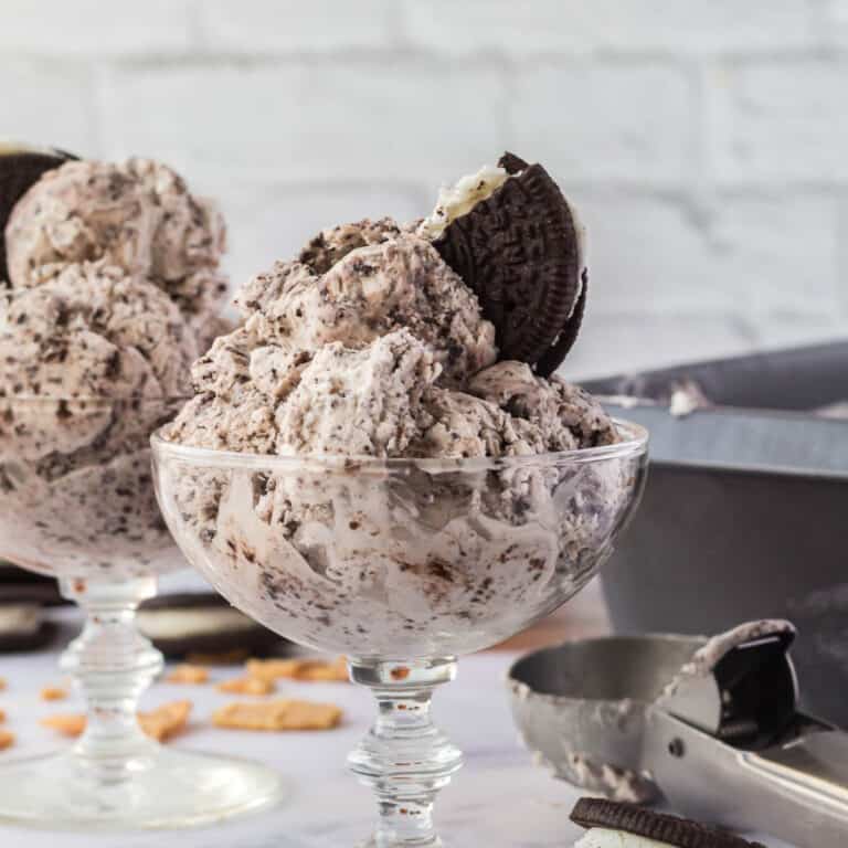 Ice cream in a bowl with a oreo on top.