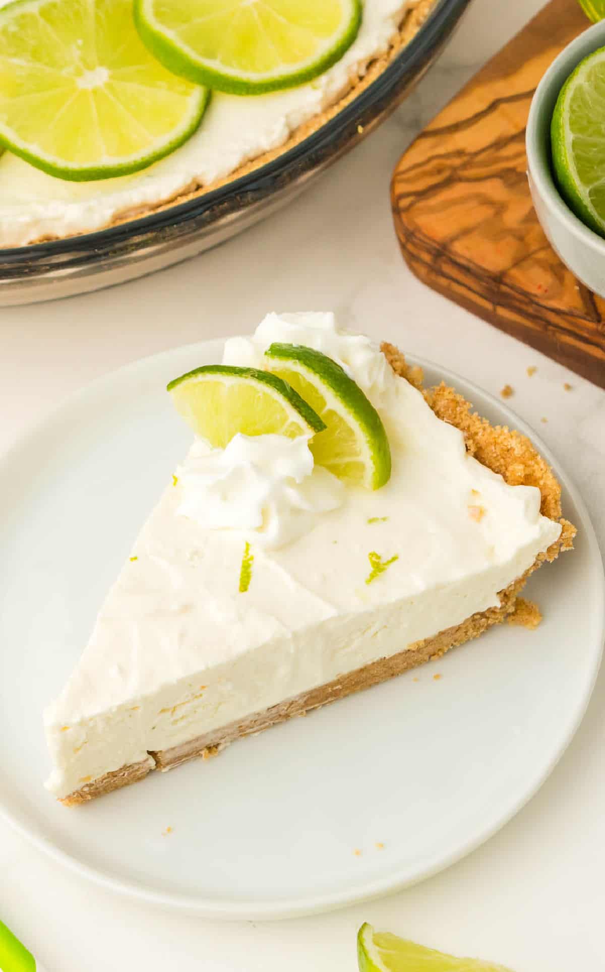 A slice of key lime pie on a white plate.