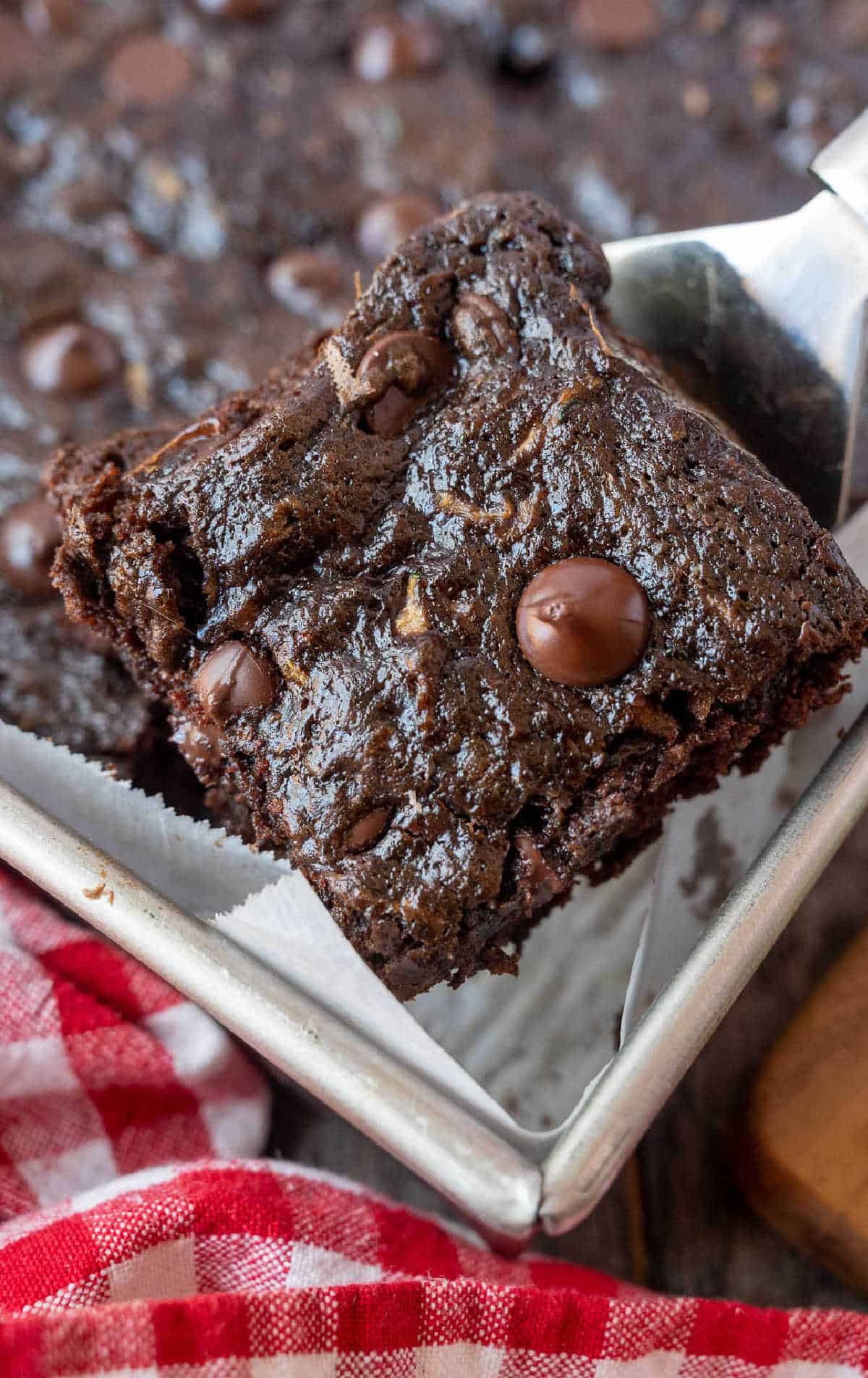 A spatula removing a brownie from the pan.