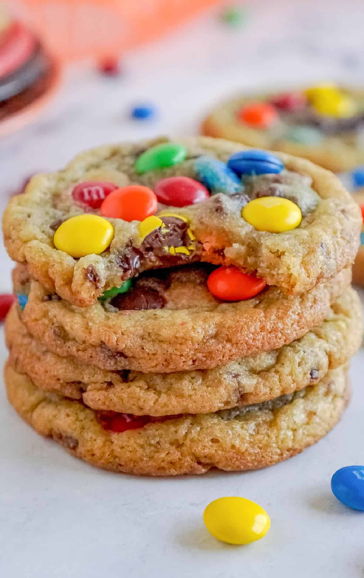 A stack of cookies with a bite out of one.