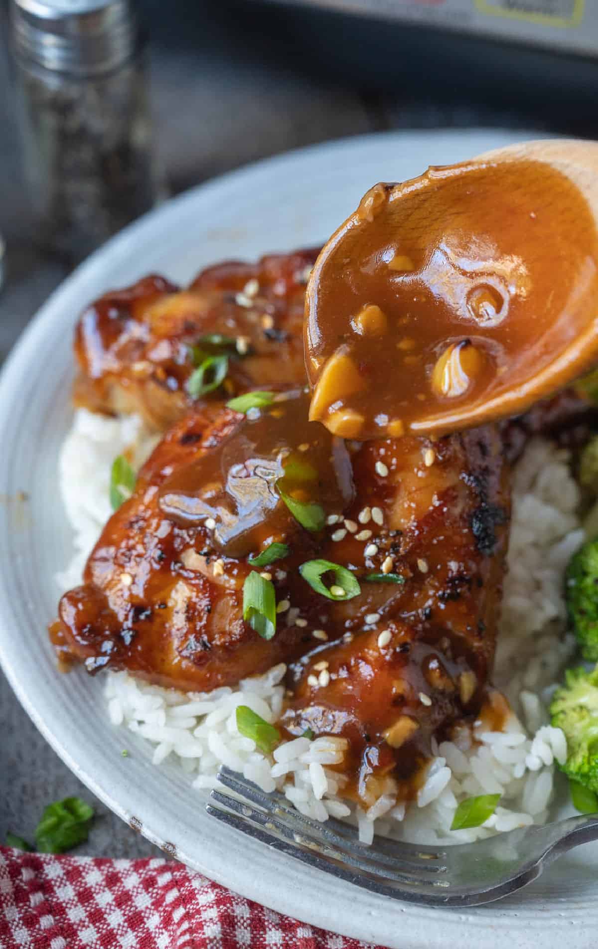 Sauce poured on top of the chicken and rice.