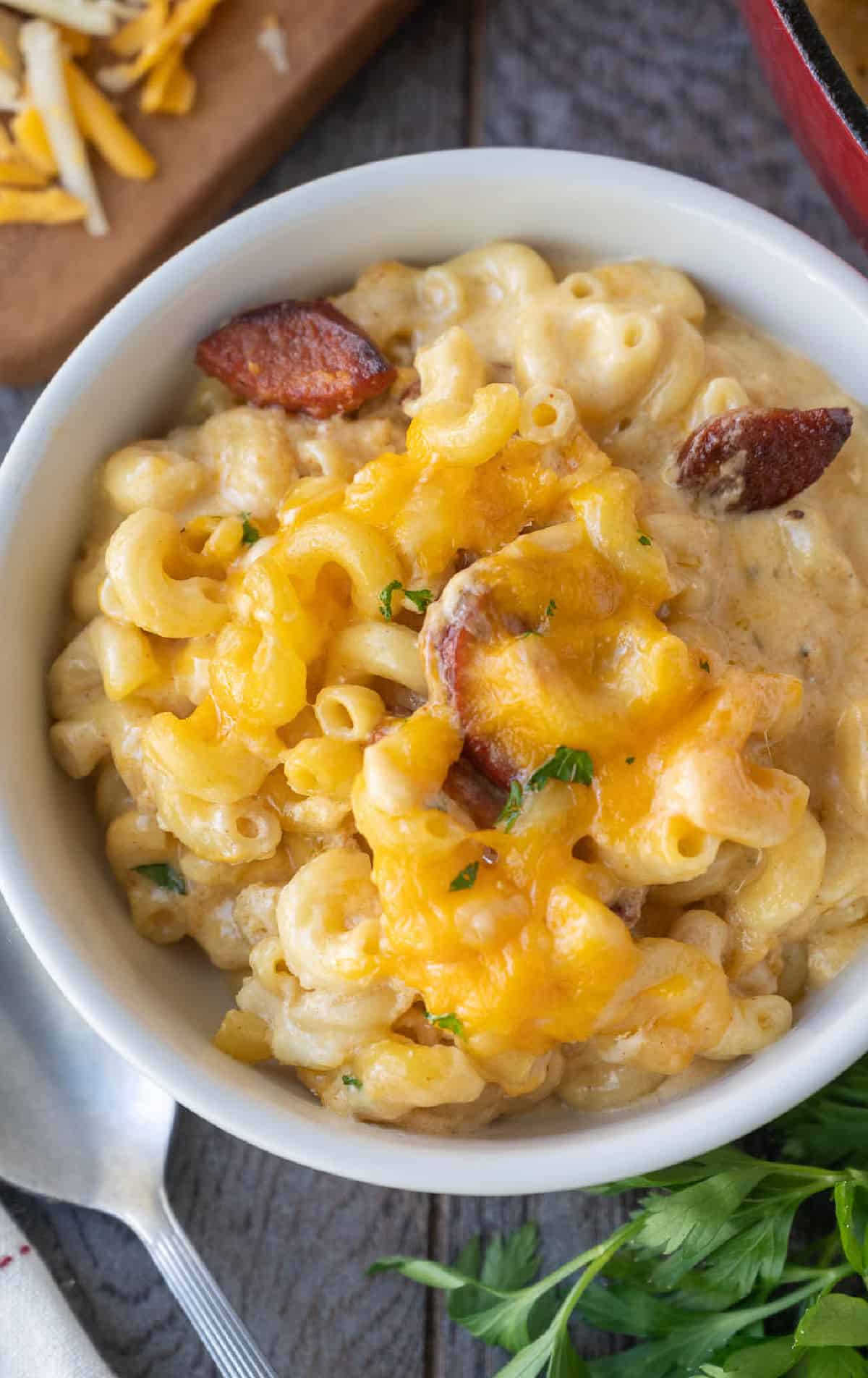 A bowl of macaroni and cheese with smoked sausage.