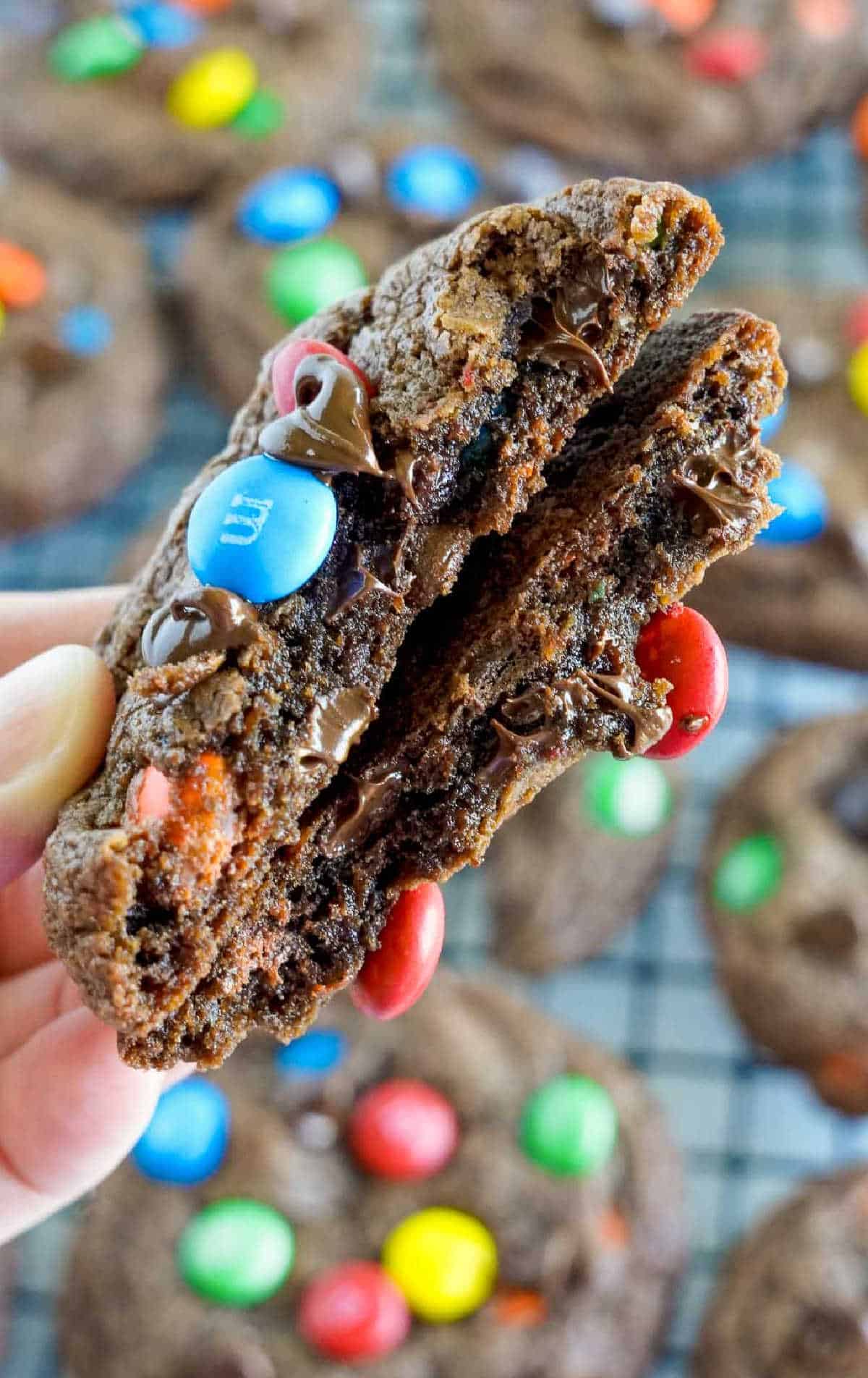 Chocolate m&m cookie broken in half.