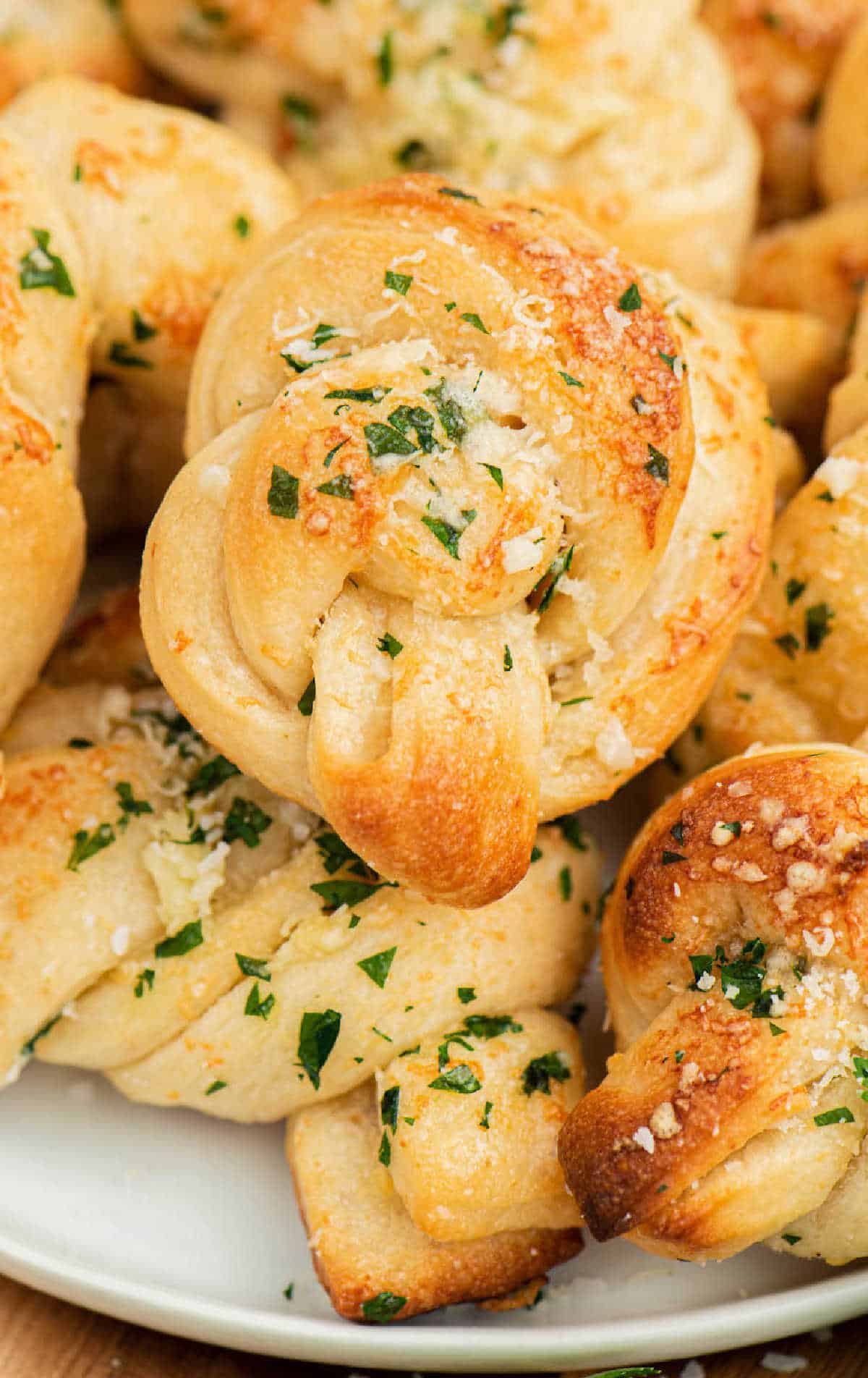 Garlic knots on a white plate.