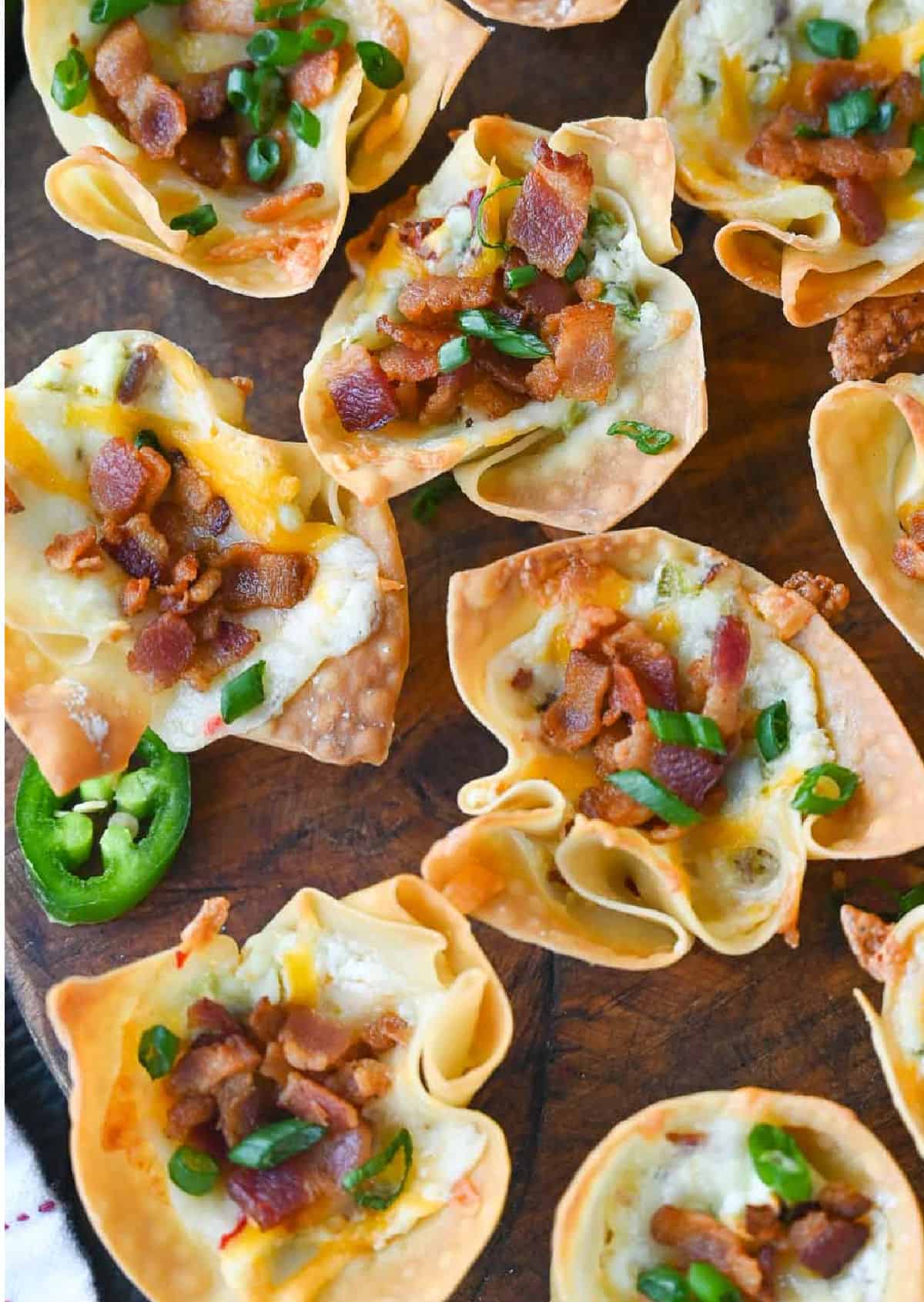 Several jalapeno popper wonton cups on a serving board.