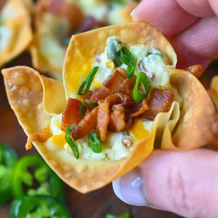 A jalapeno popper wonton cup being held.