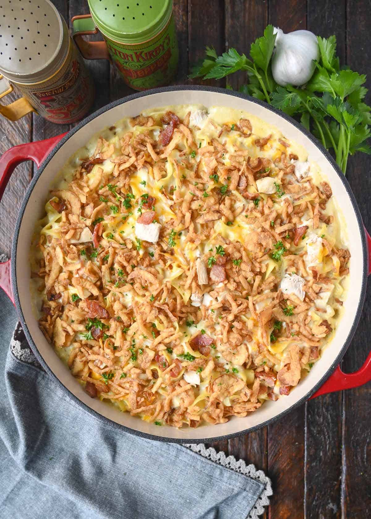 Chicken casserole in a baking dish with fried onions on top.