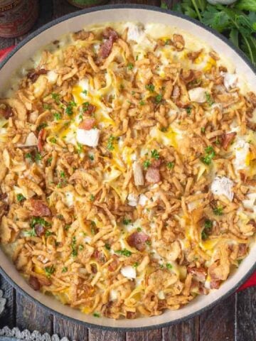 Chicken casserole in a baking dish with fried onions on top.