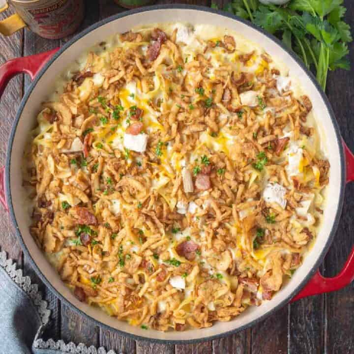 Chicken casserole in a baking dish with fried onions on top.