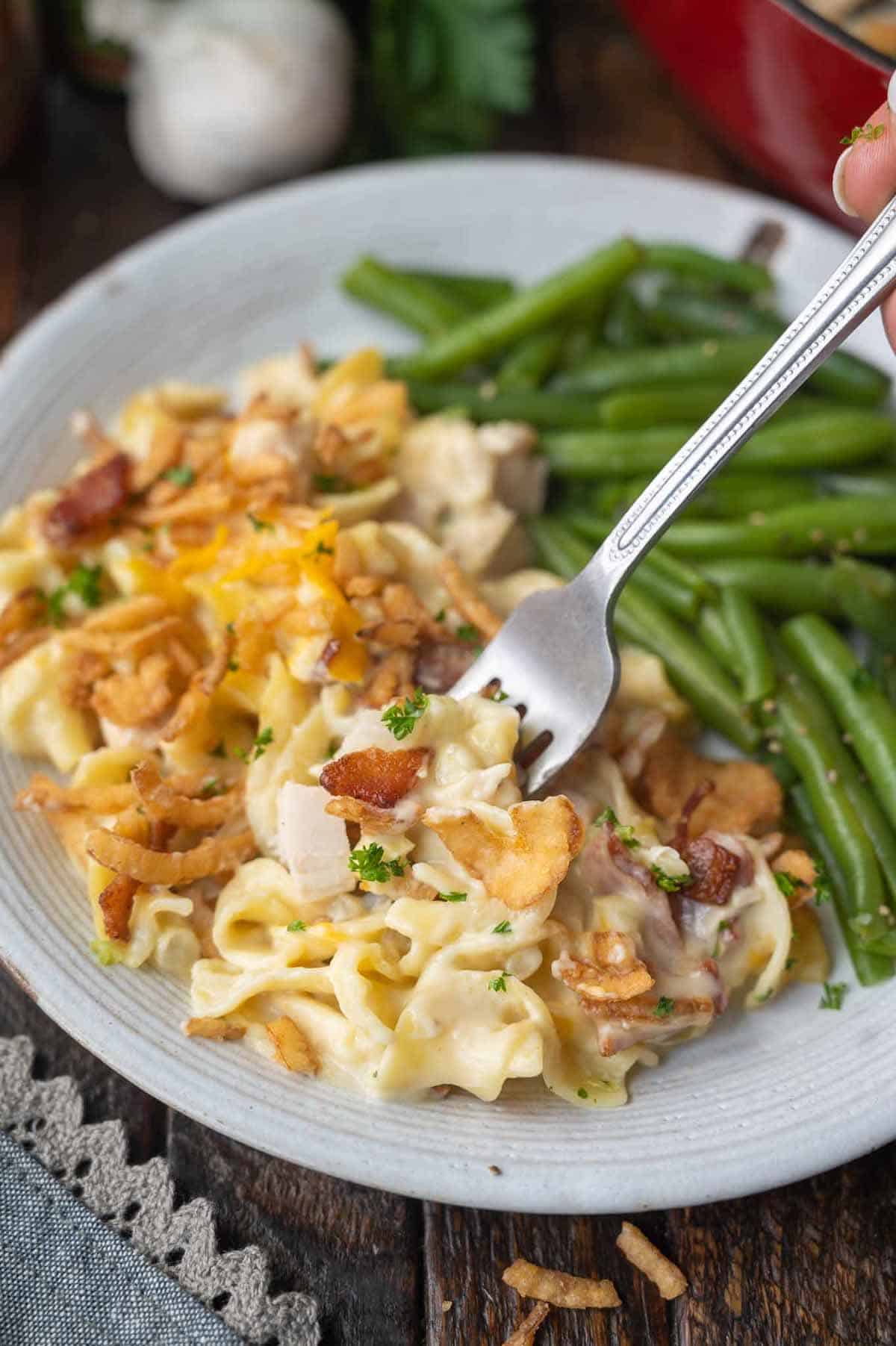 Chicken casserole on a plate with green beans.