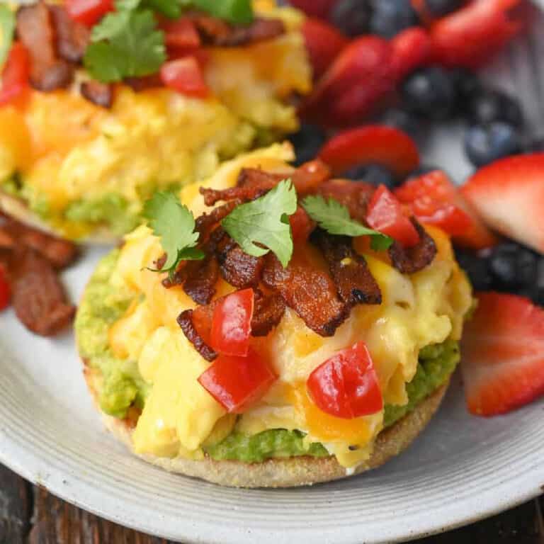 open faced breakfast sandwich on a white plate.
