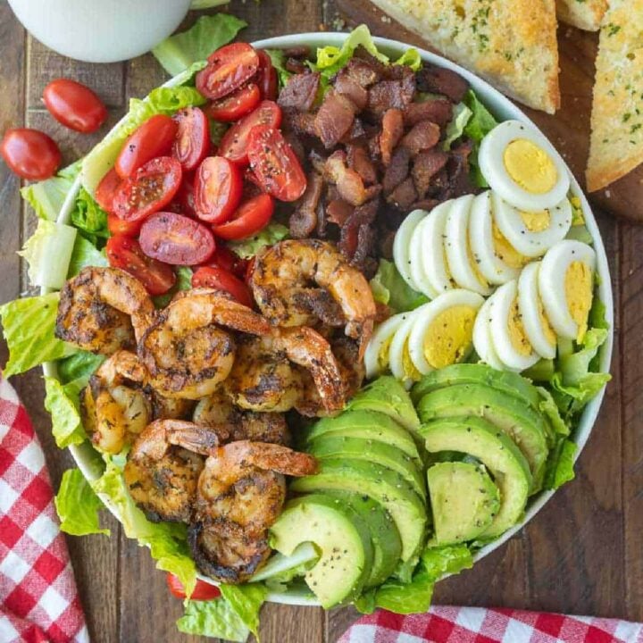 Grilled shrimp cobb salad placed in a large white bowl.
