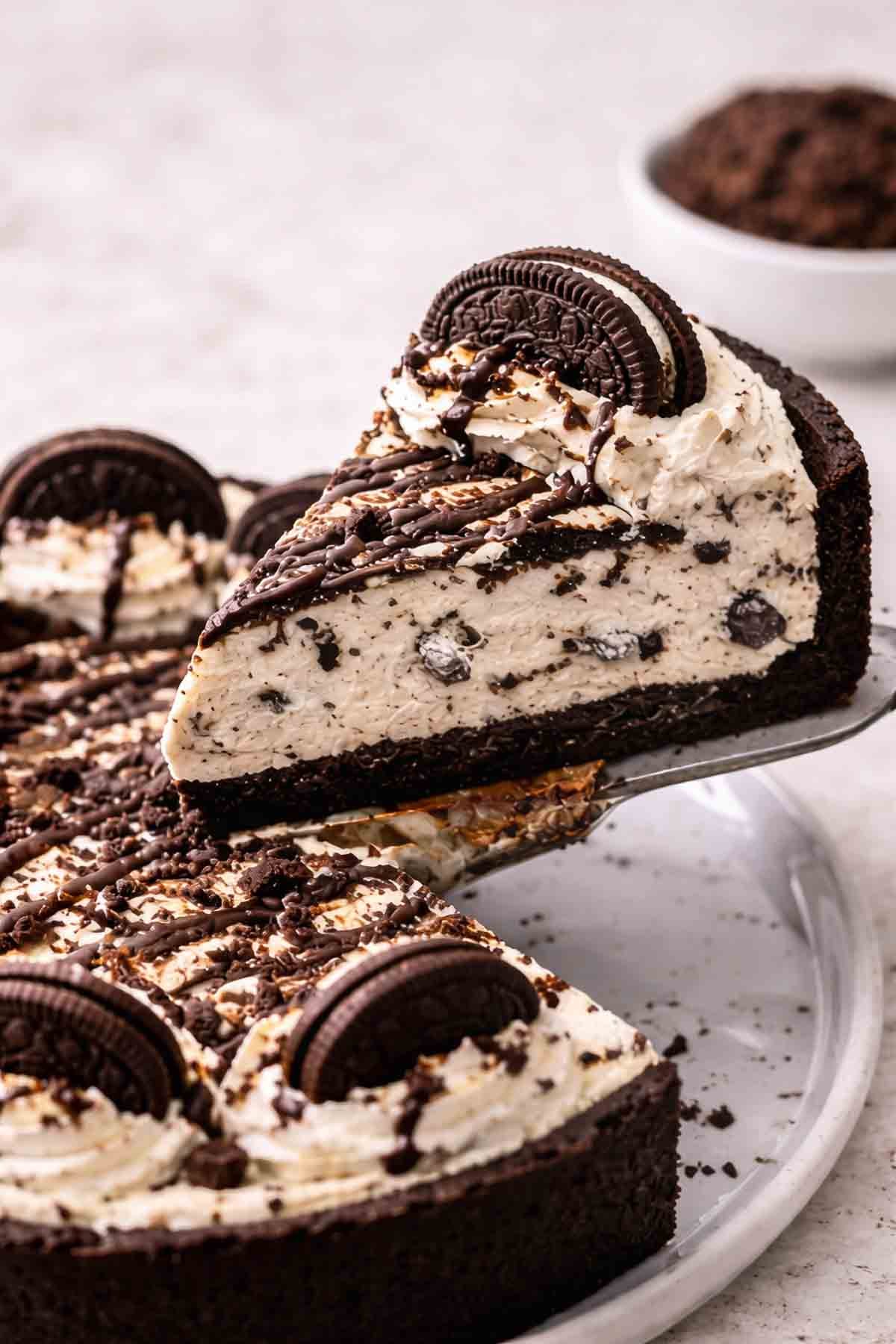 A spatula picking up a slice of no bake oreo cheesecake.