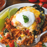 Chicken and cheese stuffed poblano peppers on some mexican rice.