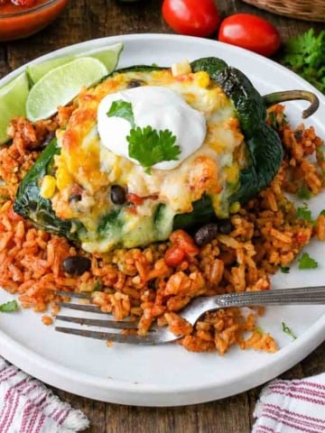 Chicken and cheese stuffed poblano peppers on some mexican rice.