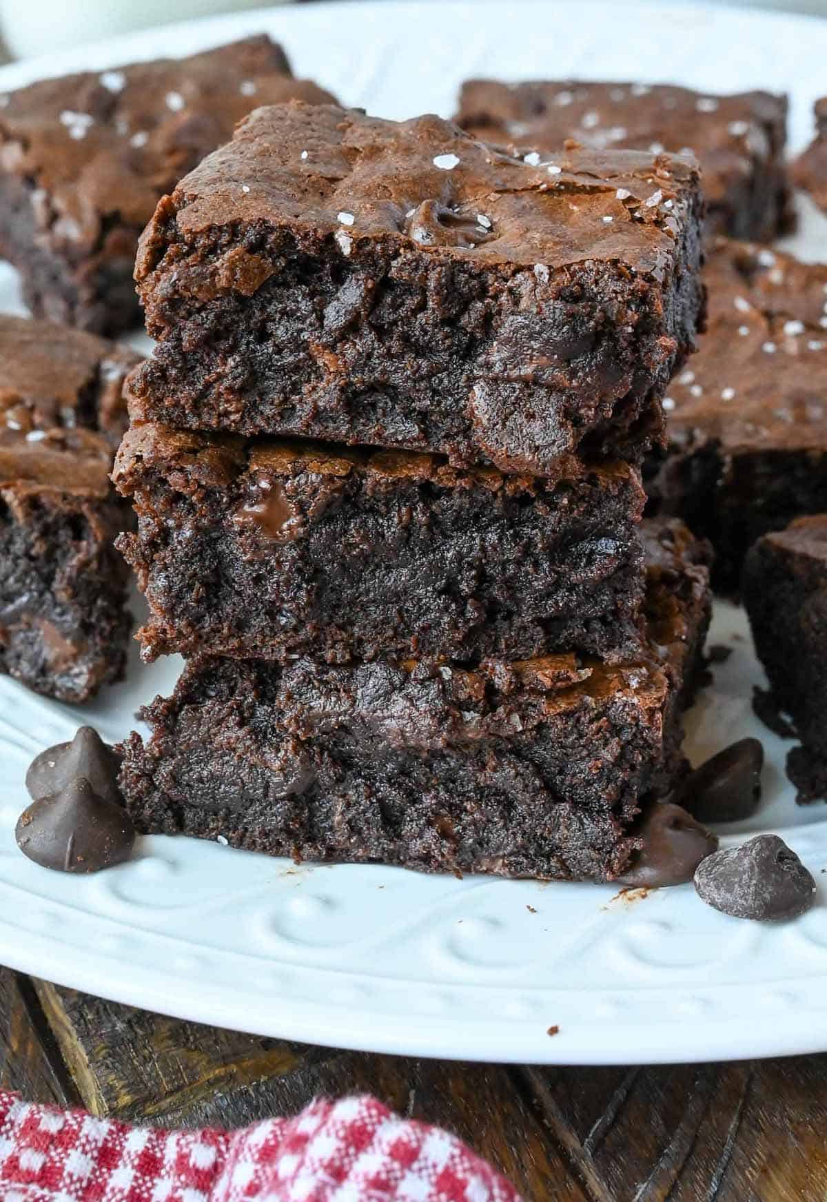 A stack of brownies on a plate.