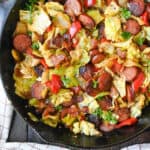 Fried cabbage and sausage in a cast iron skillet.
