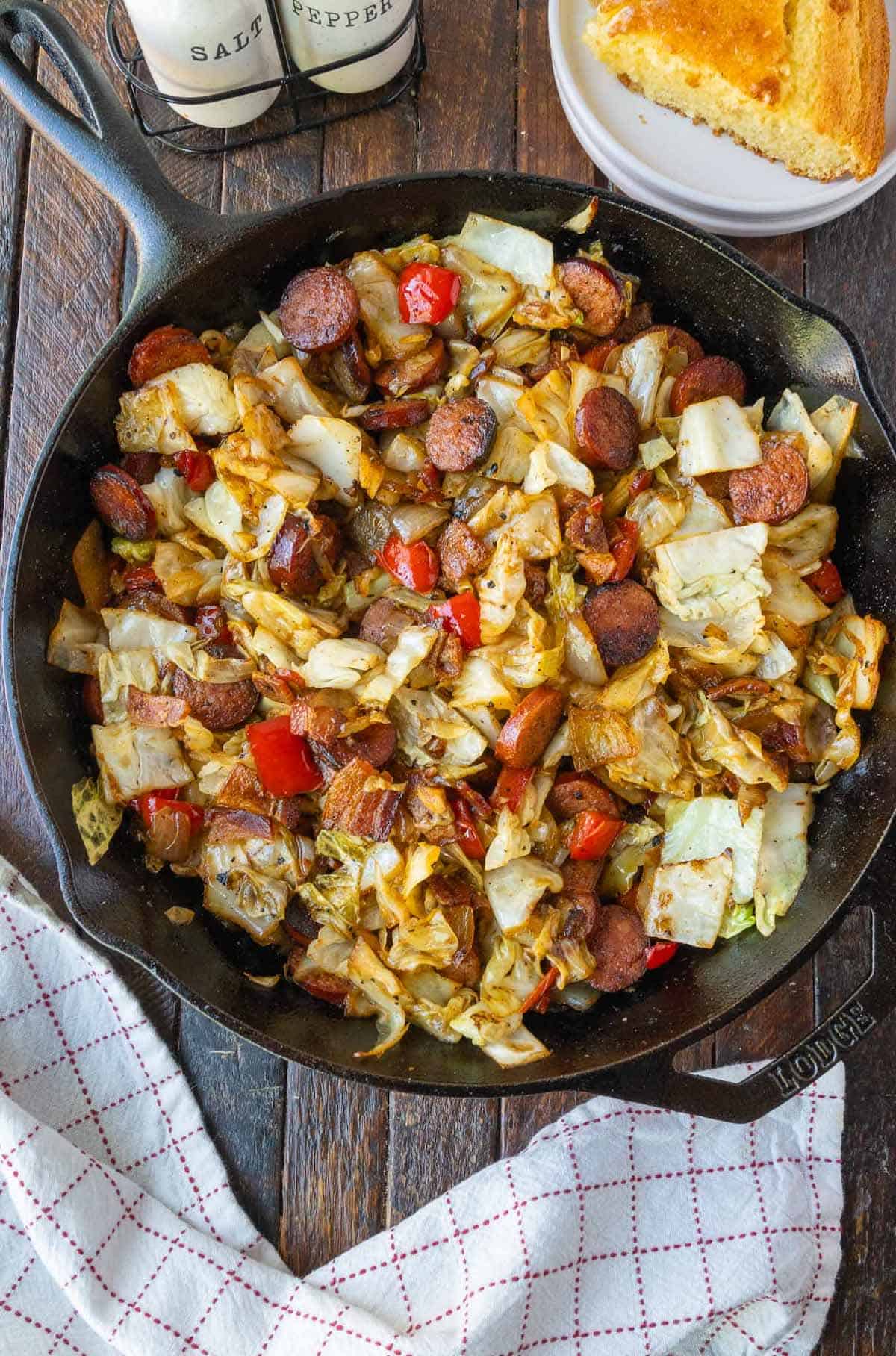 Fried cabbage with sausage in a cast iron skillet.