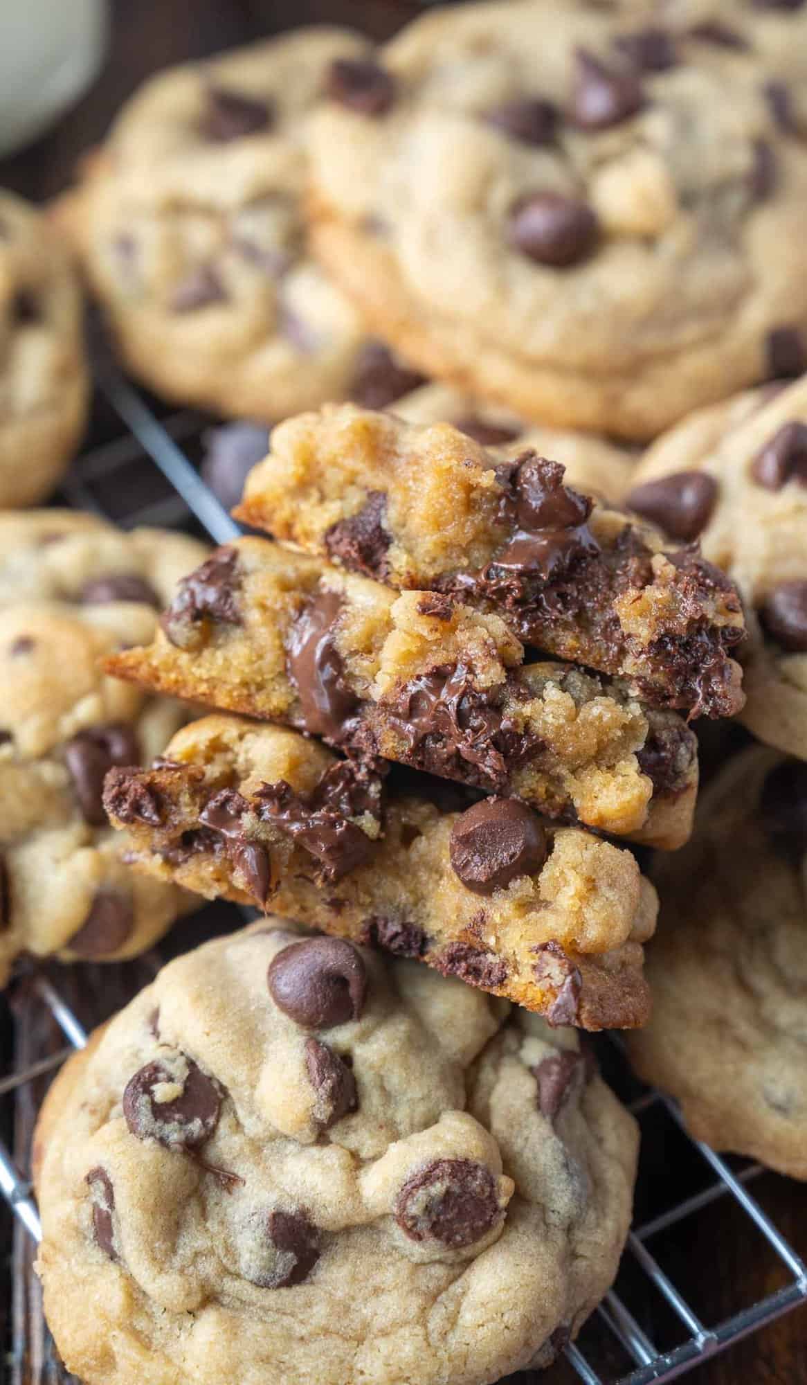 Three half-cookies stacked on top of each other, revealing melty chocolate chips.
