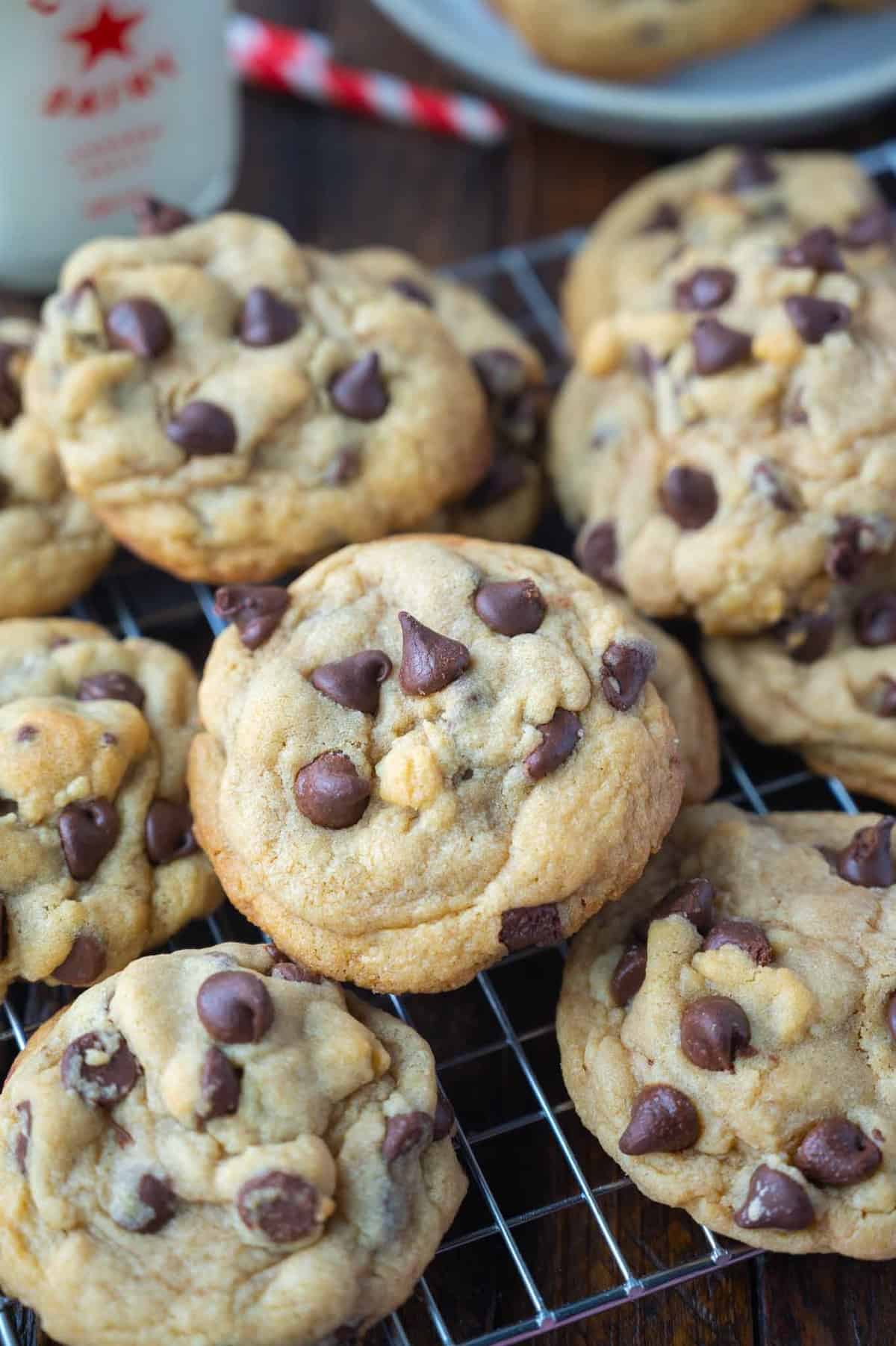 Close up of homemade chocolate chip cookies cooling on a wire rack.