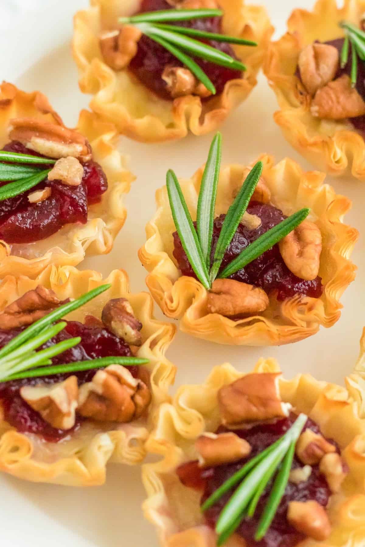 Cranberry brie phyllo cups with rosemary and pacans.