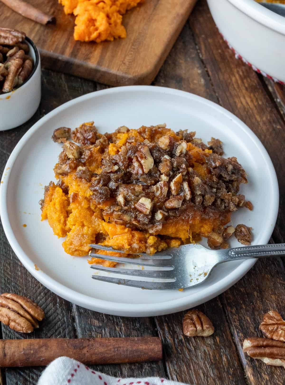 Sweet potato crunch on a plate with a fork.
