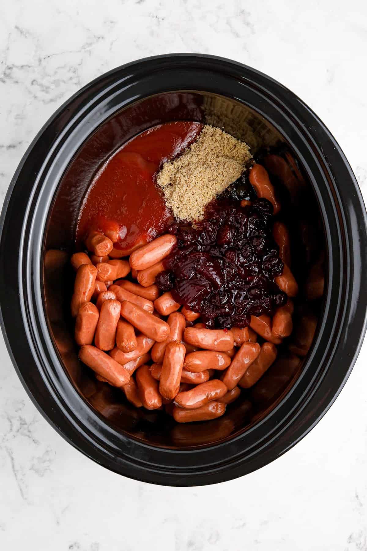 Ingredients for slow cooker cranberry little smokies in a crockpot.