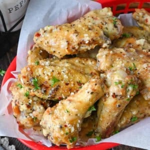 Garlic parmesan chicken wings in a basket.