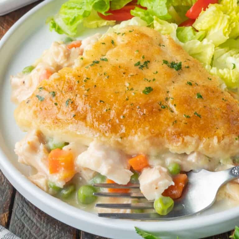 Close up shot of chicken cobbler casserole on a plate with a fork.