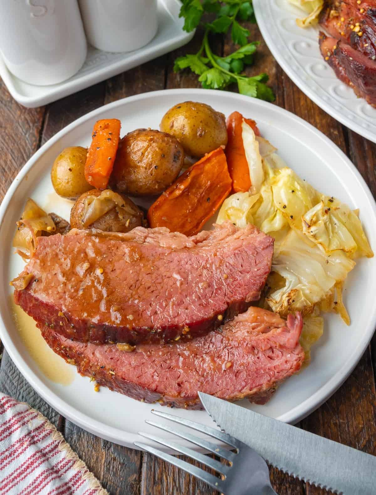 Corned beef on a plate with vegetables.