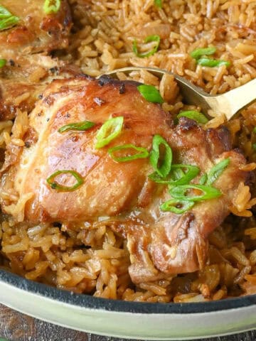 Close up of a spoonful of hibachi chicken and rice bake.