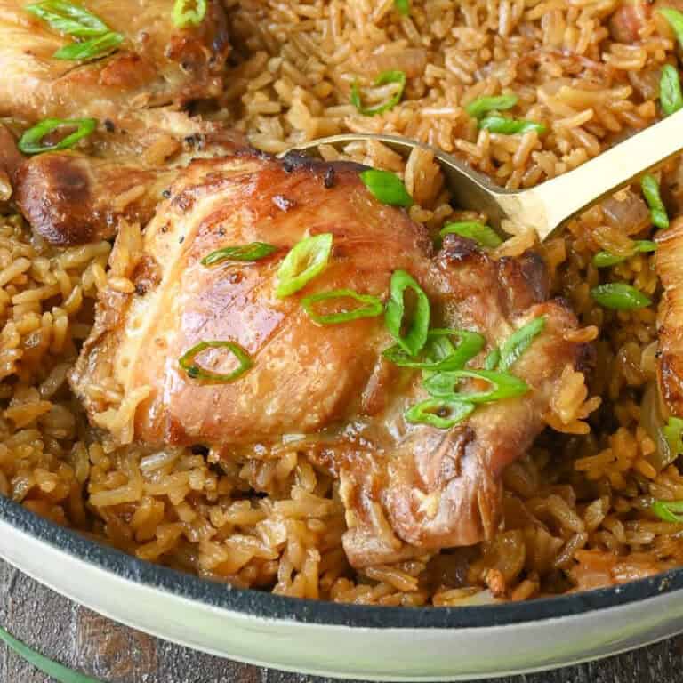 Close up of a spoonful of hibachi chicken and rice bake.