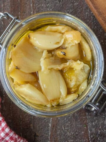 Roasted garlic in a glass jar.