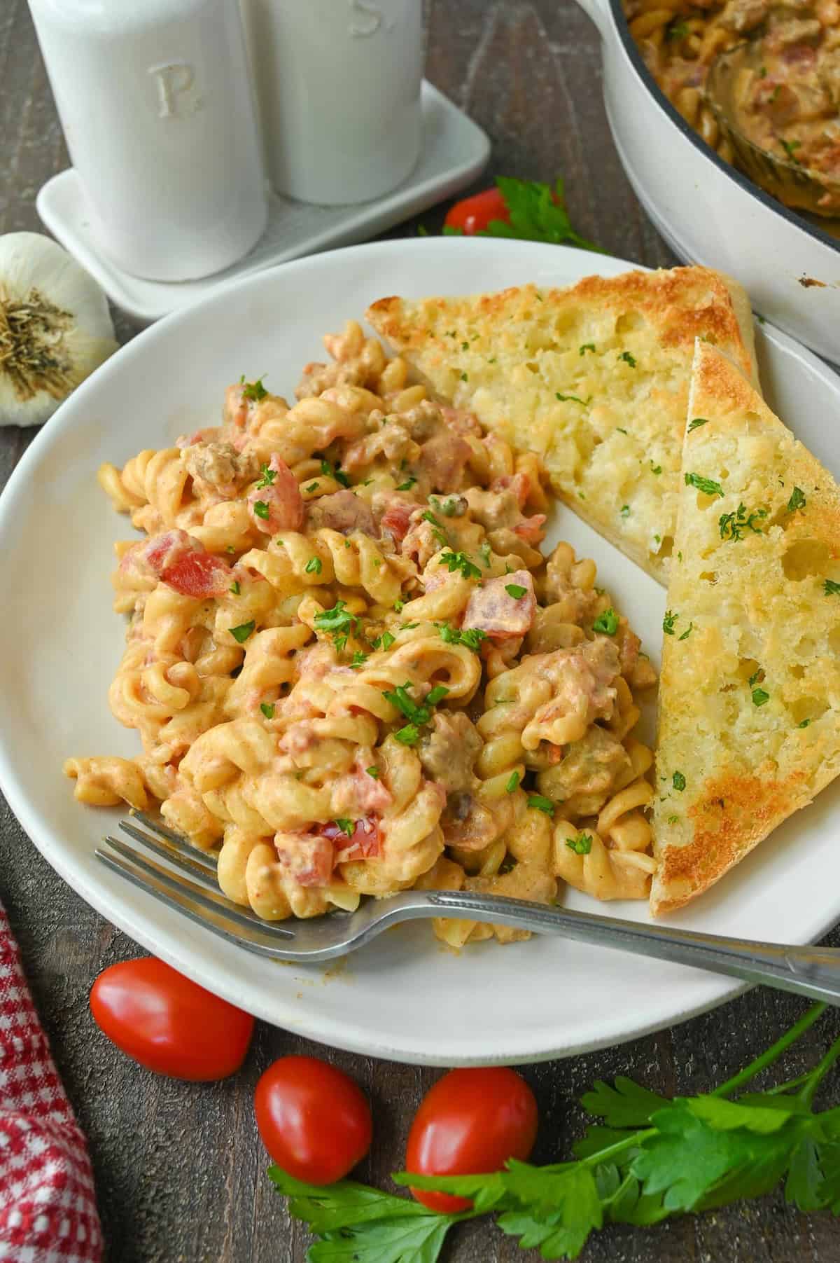Rotel pasta on a plate with garlic bread.