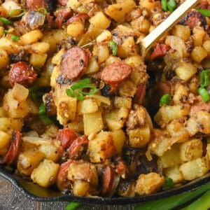 Fried potatoes with sausage in a skillet.
