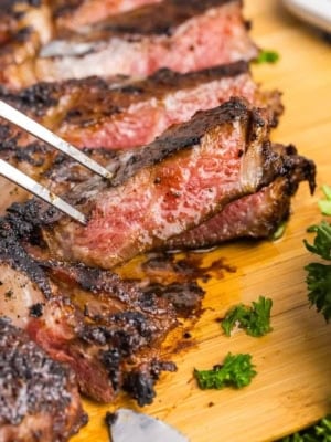 A fork picking up a slice of coffee rubbed steak.