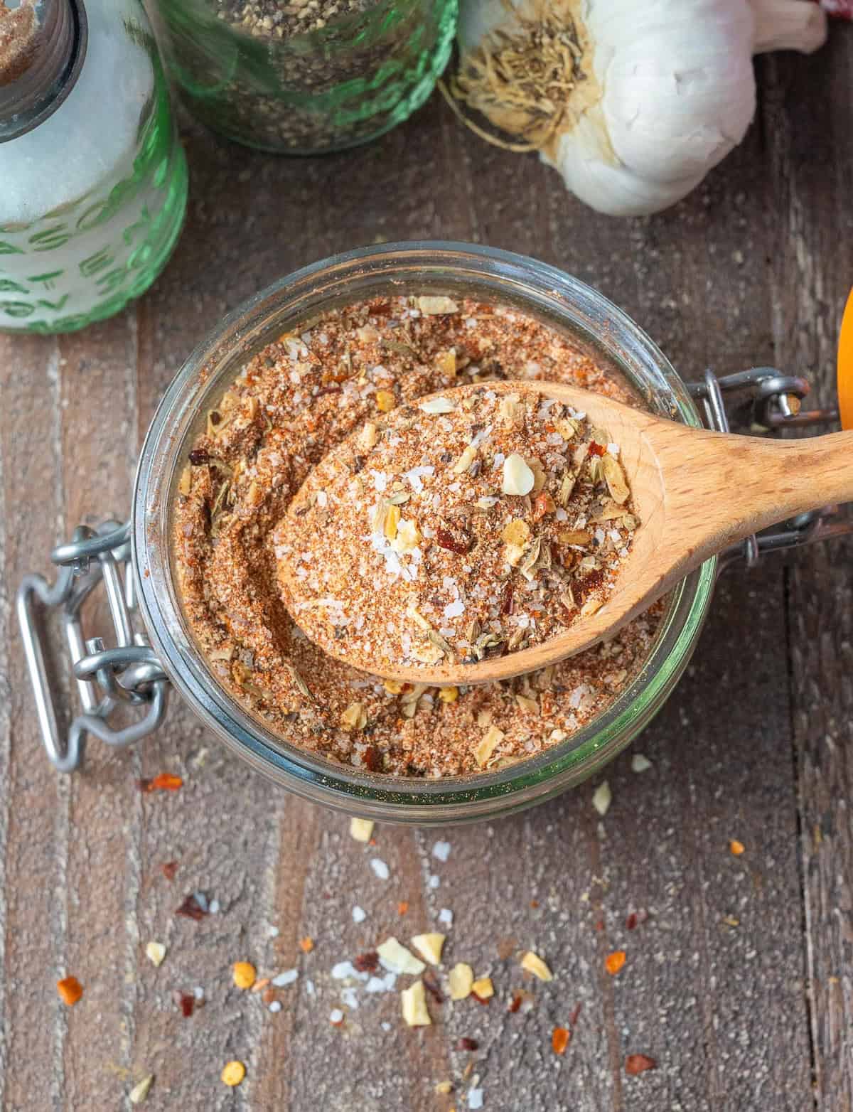 A small wooden spoon scooping up some beef rub.