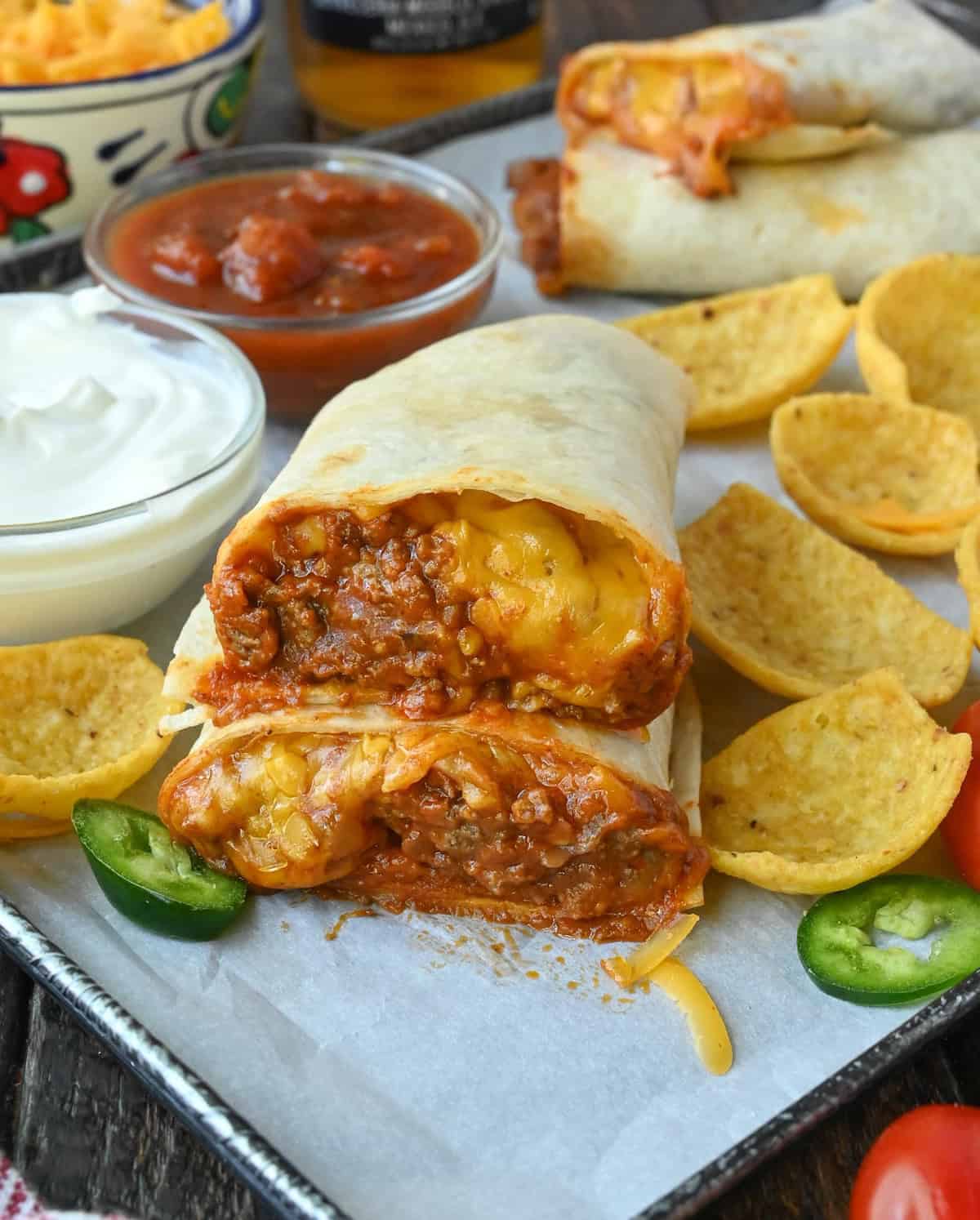 A chili cheese burrito cut in half and stacked.