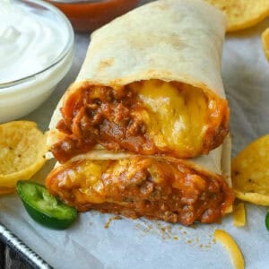 Close up of two halves of chili cheese burrito.