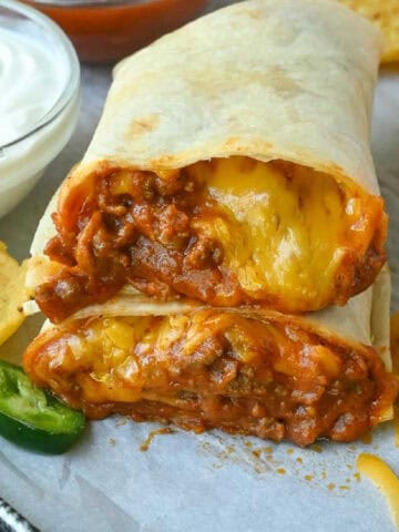 Close up of two halves of chili cheese burrito.