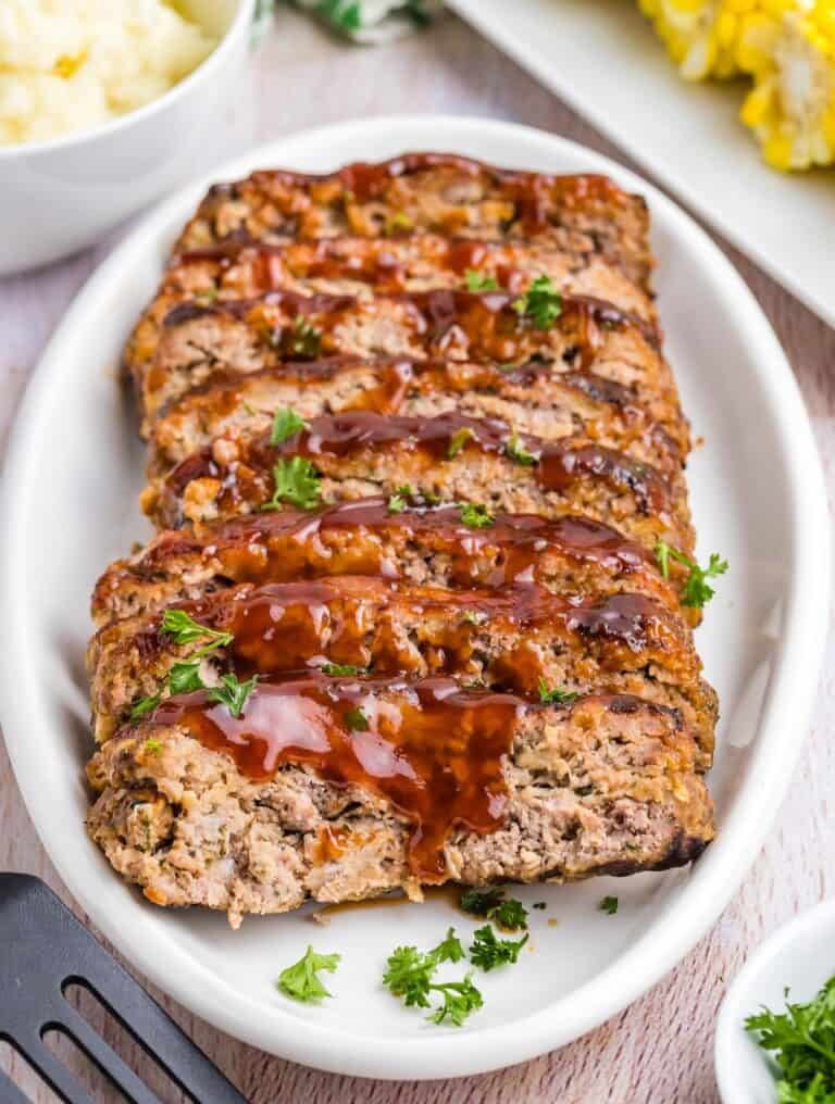 A platter of slices of grilled meatloaf.