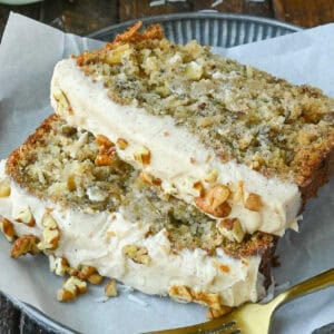 Close up of two pieces of hummingbird bread with cream cheese frosting.