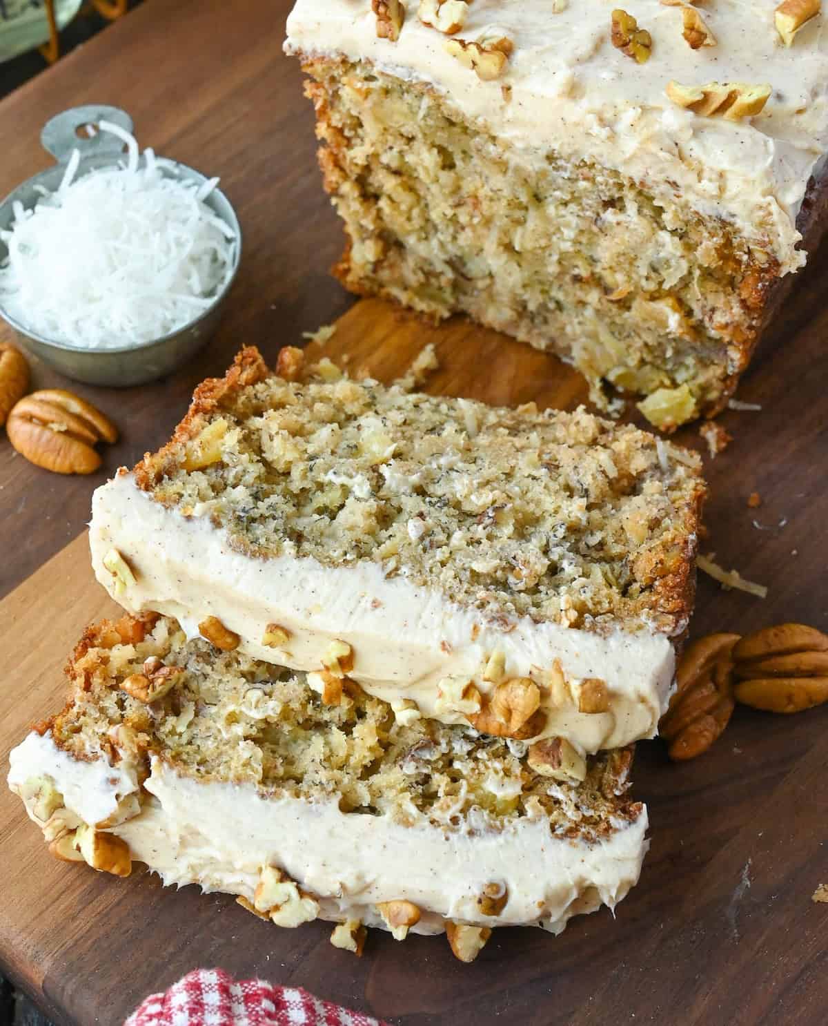 Two slices of hummingbird bread next to a loaf.