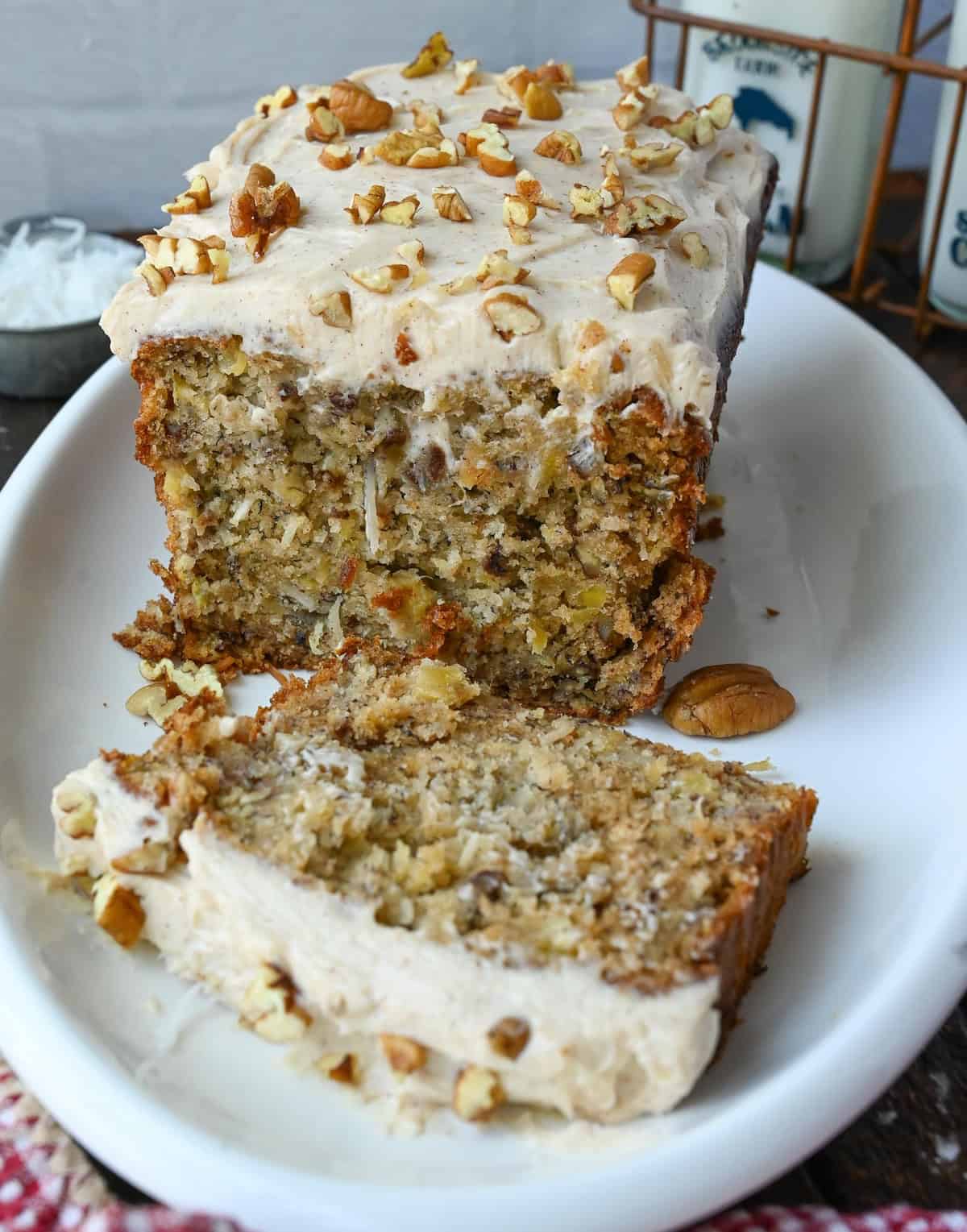 A plate with a loaf of hummingbird bread and a single piece.