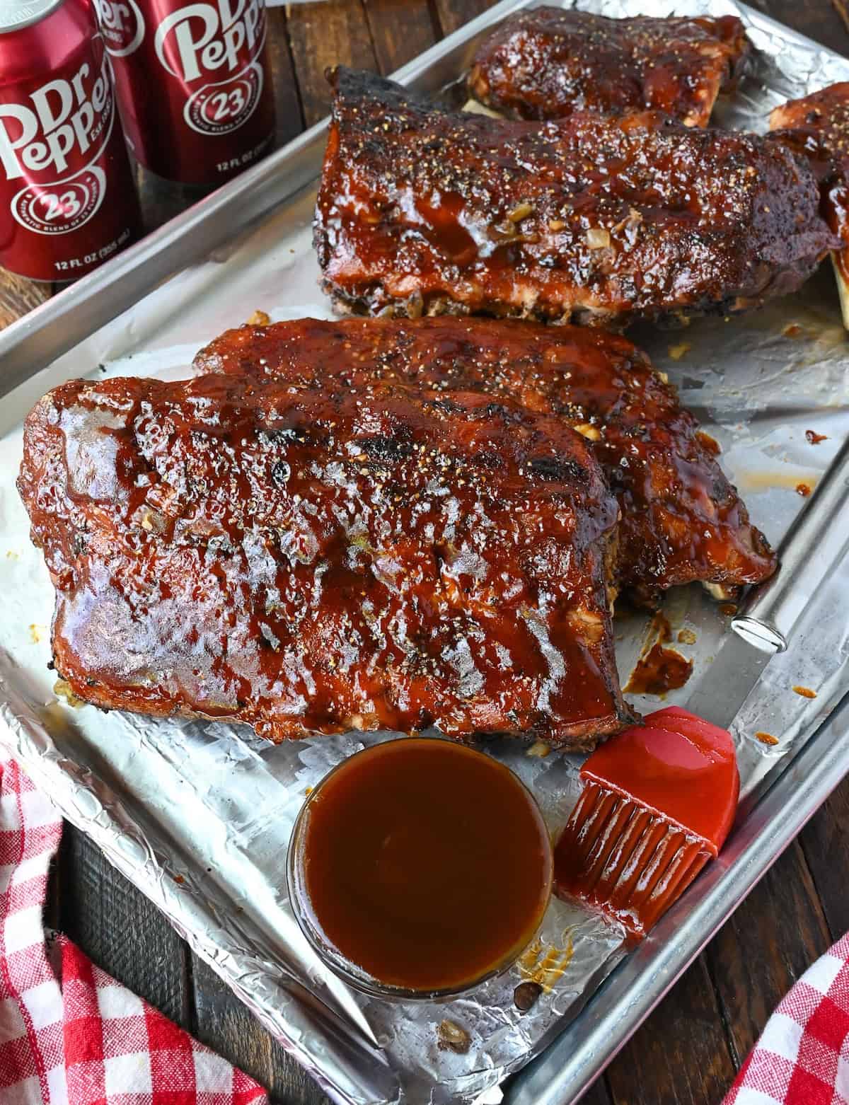 Chunks of slow cooker ribs on a baking sheet.