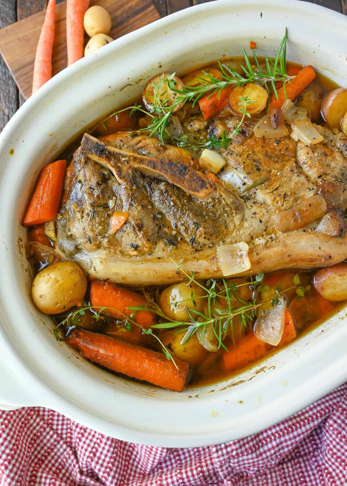 Overhead view of a slow cooker with a pork roast and veggies.