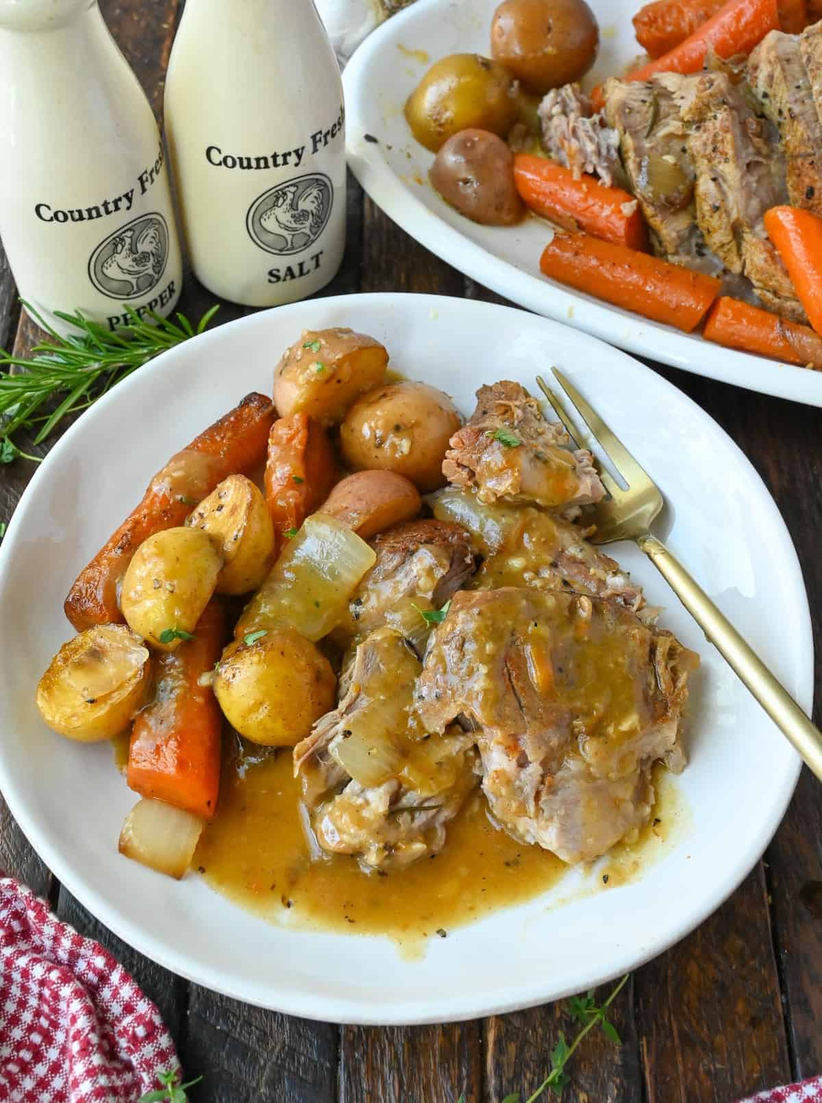 A plate of slow cooker pot roast with veggies.